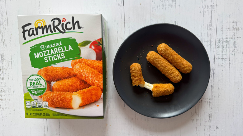 Farm Rich mozzarella sticks on plate next to package on table