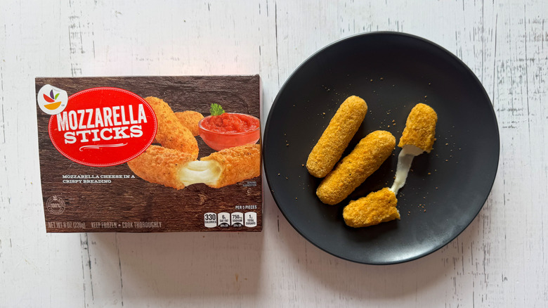 Stop & Shop mozzarella sticks on a plate near packaging on a table