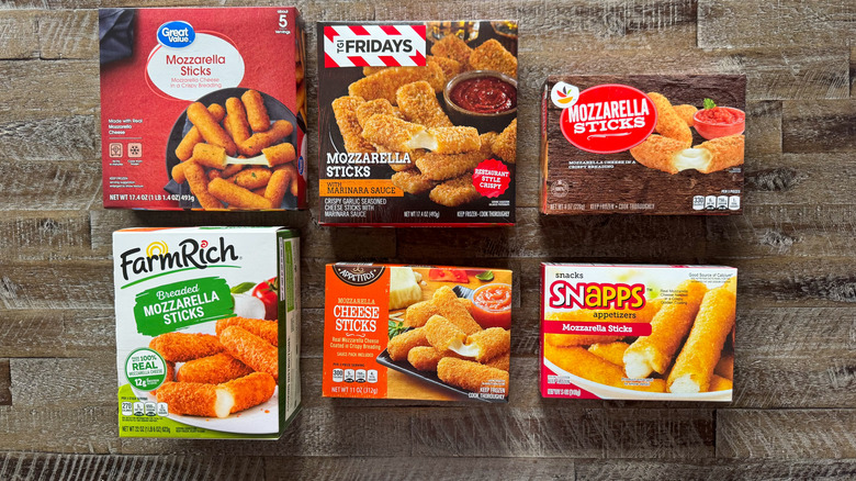 Boxes of frozen mozzarella sticks on wooden surface