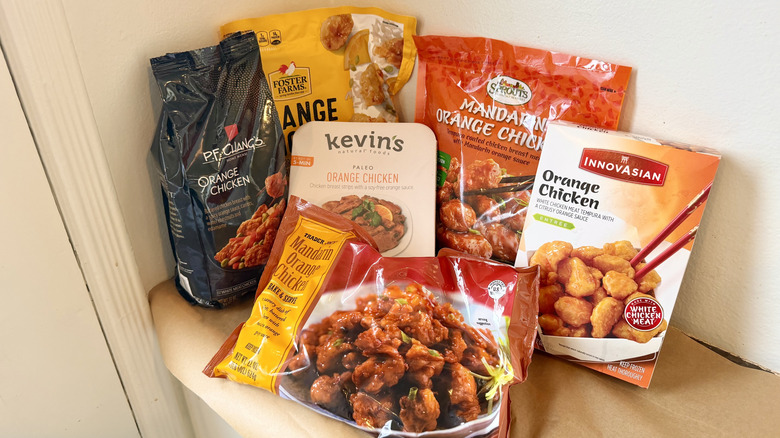 six orange chicken packages arranged neatly on a kitchen countertop