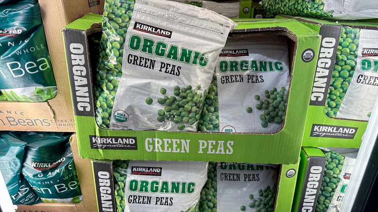 Bags of Kirkland Signature Organic Green Peas on display in Costco freezers