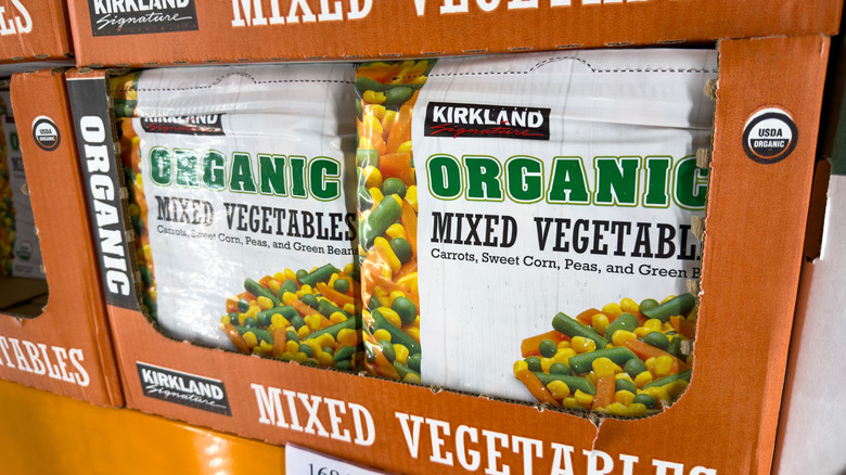 Bags of Kirkland Signature Organic Mixed Vegetables on display in Costco freezers