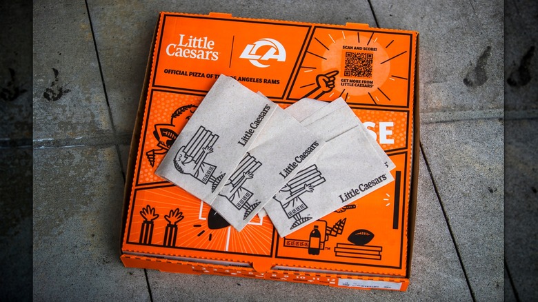 Little Caesars pizza box with fresh napkins laying on top