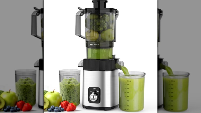 COWSAR juicer with cups of juice and fruits and veggies on side