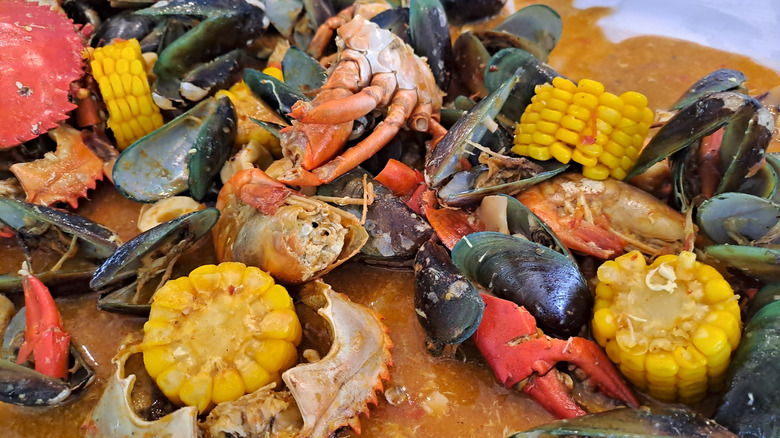 a close up of a seafood boil spread out on a table