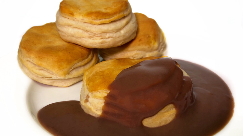 A stack of biscuits is smothered in chocolate gravy.