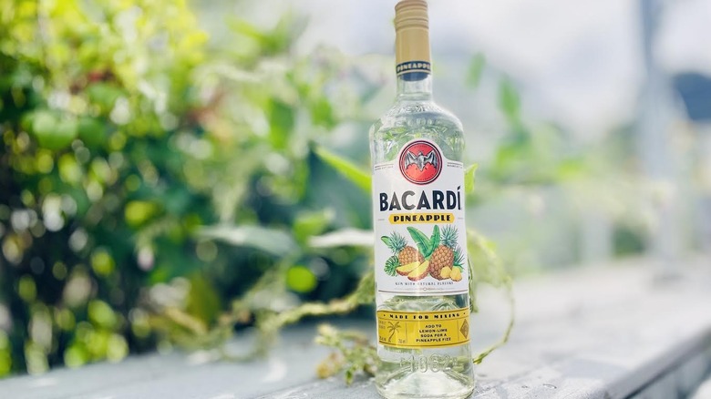 Bottle of Bacardi Pineapple on outdoor ledge