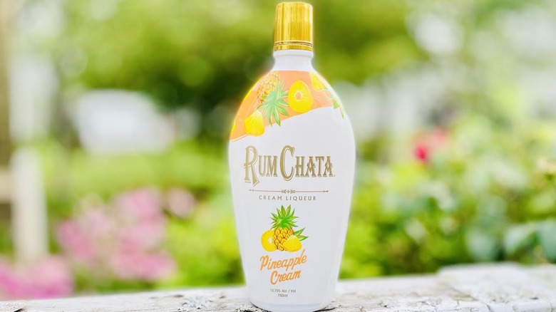Bottle of Rum Chata Pineapple Cream Liqueur on outdoor ledge
