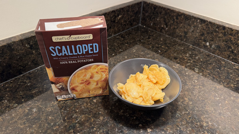 Box of scalloped potatoes with bowl on countertop