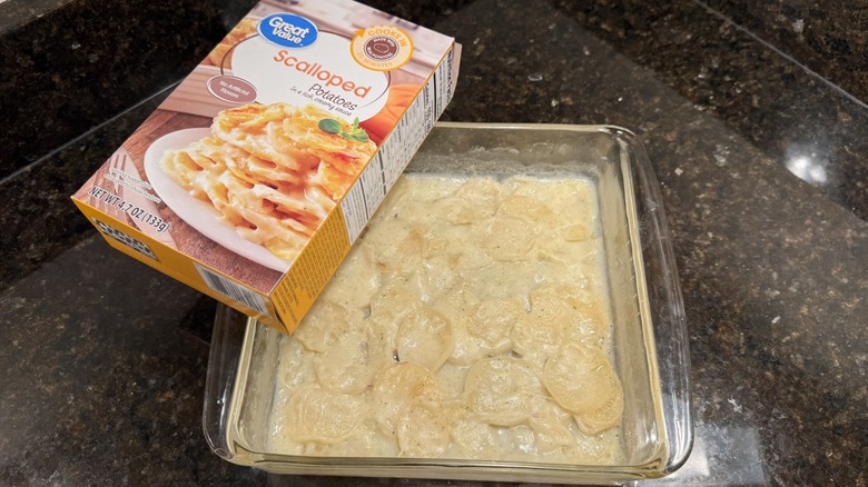 Tray of scalloped potatoes with box on countertop