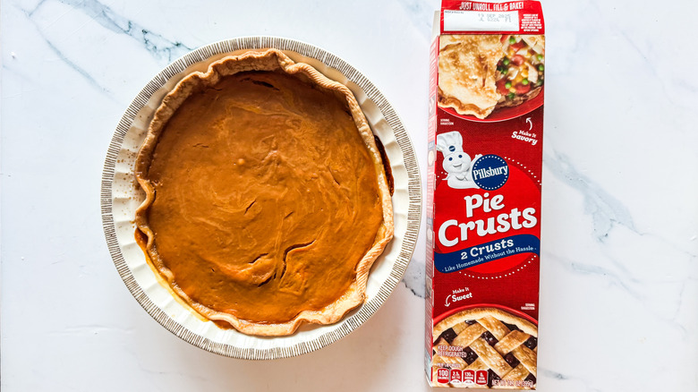 Pillsbury pie crust packaging beside pumpkin pie