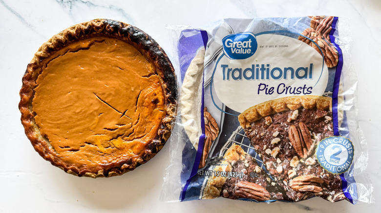 Great Value pie crust packaging beside pumpkin pie