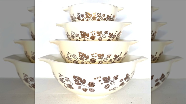 Stack of golden gooseberry Pyrex bowls.