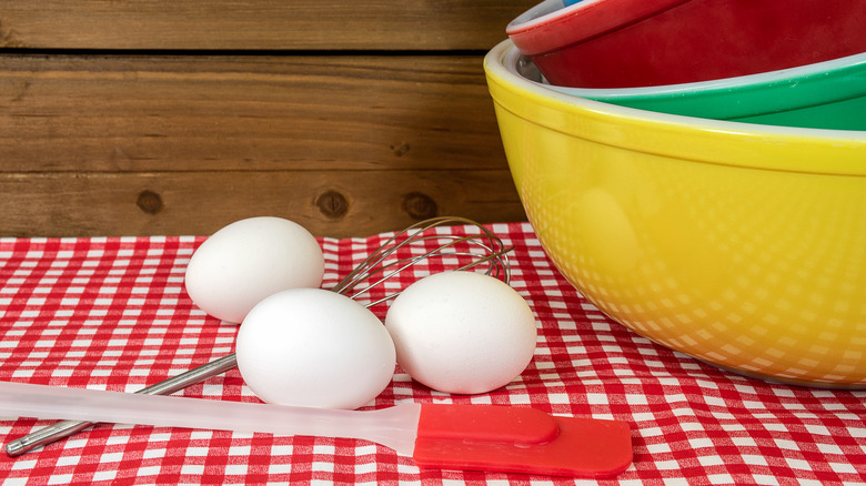 Pyrex bowls stacked next to baking supplies.