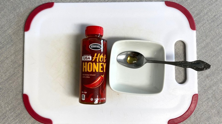 Aldi Berryhill hot honey displayed with a sample in a spoon