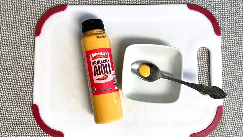 Aldi Sriracha aioli spread displayed with a sample in a spoon