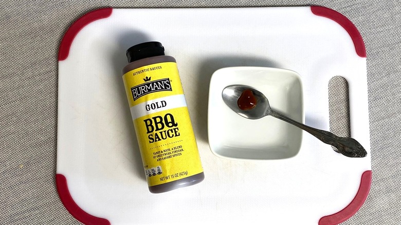 Aldi gold bbq sauce displayed with a sample in a spoon