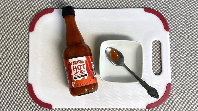 Burman's hot sauce from Aldi displayed with a sample