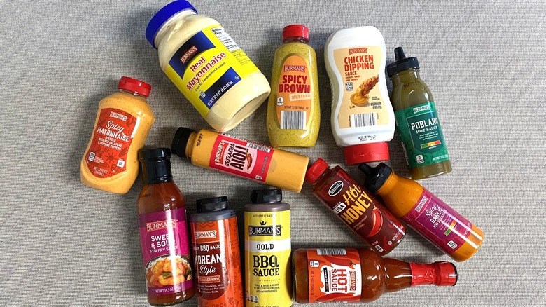 12 Aldi sauces laying on a table in a random formation