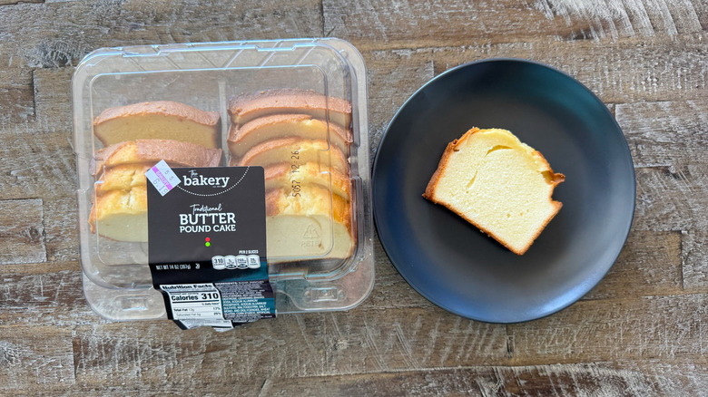 black plate with slice of pound cake on wooden surface
