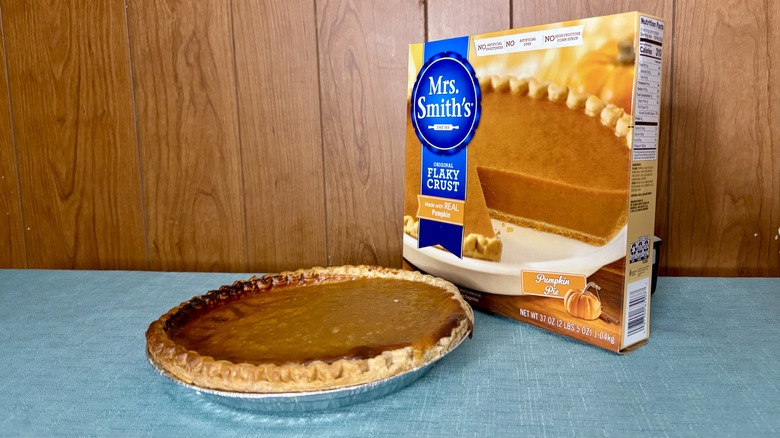 Mrs. Smith's brand pumpkin pie sits in pie tin in front of packaging