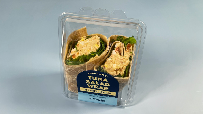Trader Joe's Tuna Salad Wrap in a plastic container on a light blue background