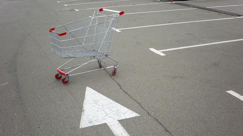 Empty shopping cart stranded in parking lot