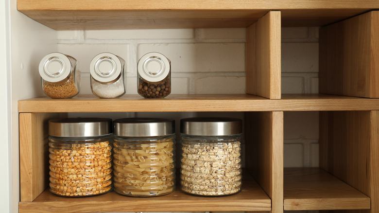 Pantry staples stored on open shelves in the kitchen
