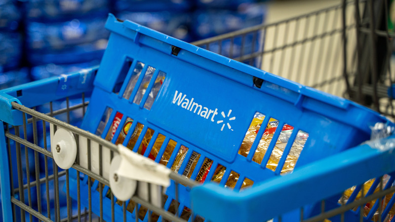 Blue Walmart basket filled with food inside a shopping cart