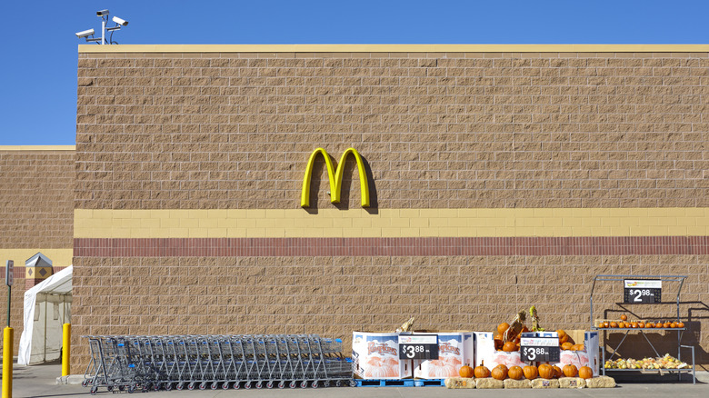 Side of a Walmart center with the McDonald's Golden Arches on the wall