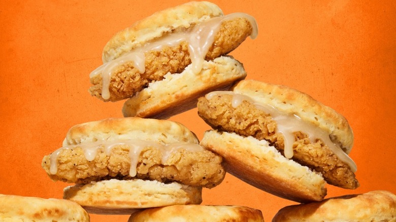 a pyramid of honey butter chicken biscuits with orange background