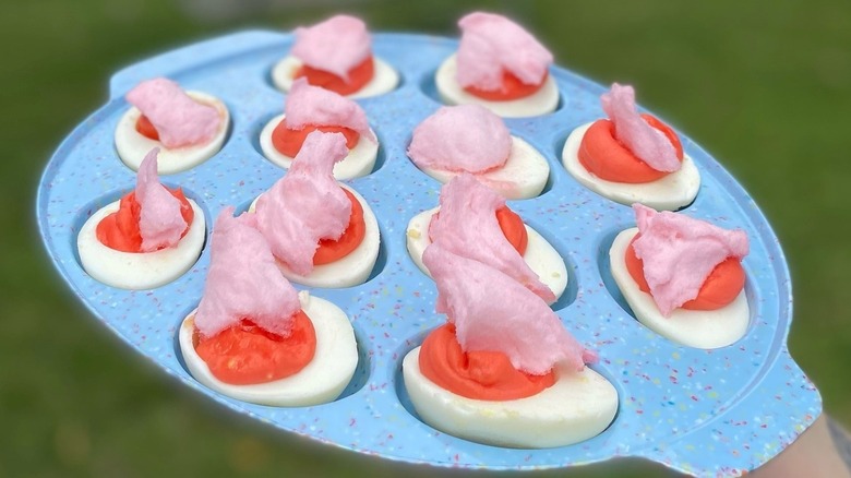 eggs with pink filling and cotton candy pieces on top