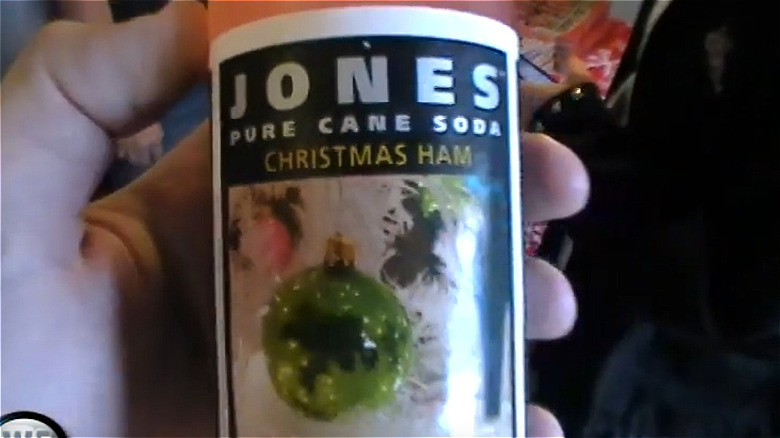 Hand holding a bottle of Jones Christmas Ham Pure Cane Soda