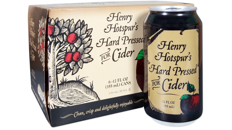 A 12-ounce can of Henry Hotspur's Hard Pressed for Cider in front of a cardboard carrying case for 6 cans of the cider