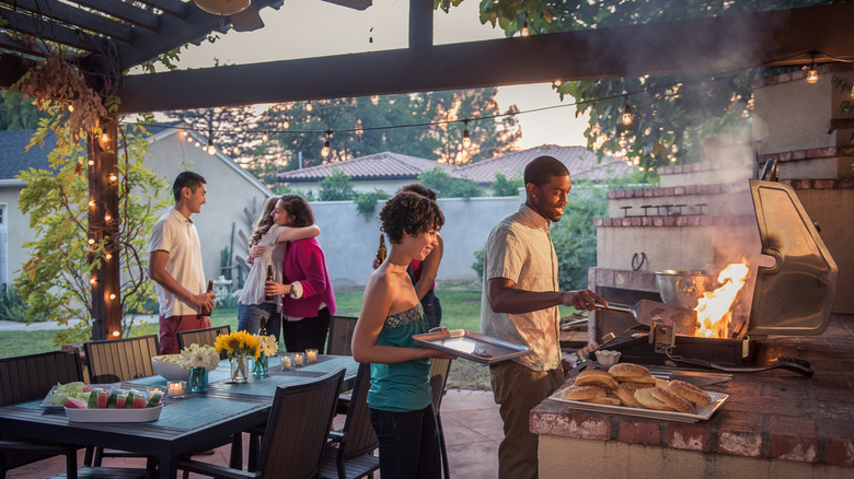 A group of friends grilling in a backyard