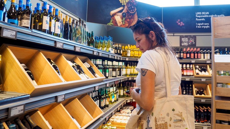 Woman shopping the alcohol section of an Aldi grocery store