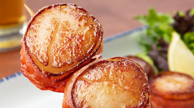Two bacon-wrapped scallops on a skewer at Red Lobster