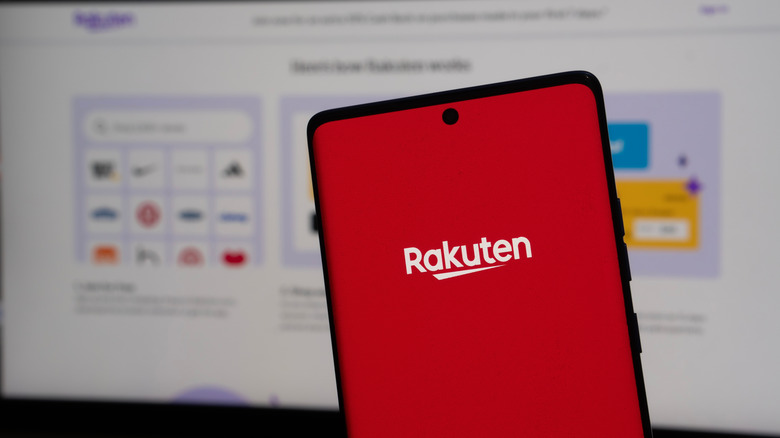 Smartphone with Rakuten logo in front of a computer screen
