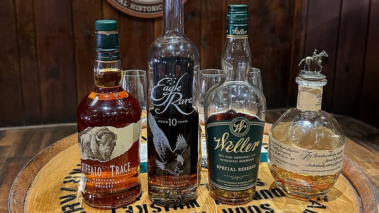 Assorted Buffalo Trace Distillery bourbons lined up on a barrel