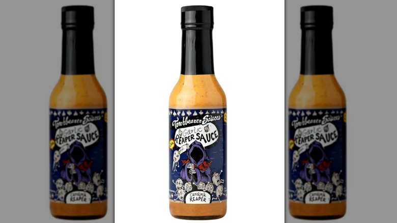 A bottle of Torchbearer hot sauce against a white background