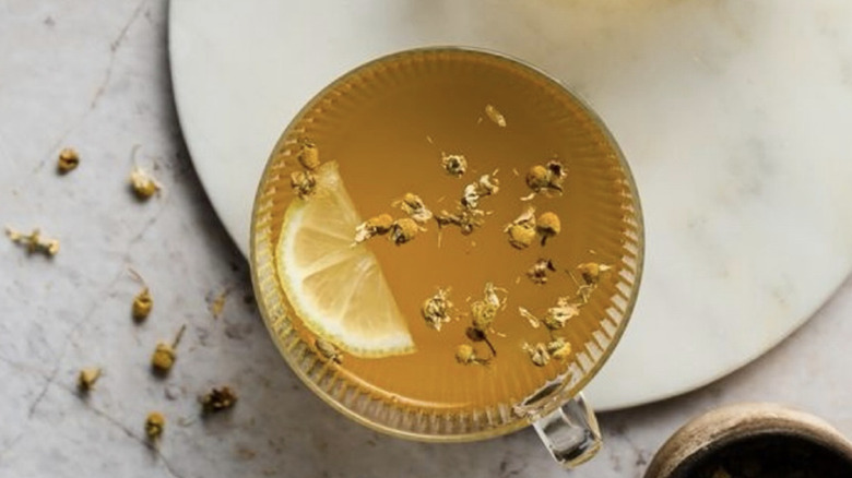 A top view of a cup of ashwagandha tea with a lemon slice