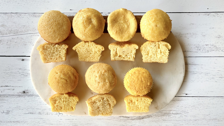 Different whole and halved yellow cupcakes on a serving platter