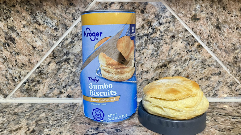 Opened can of Kroger Butter Flavored Jumbo Biscuits with a cooked one alongside