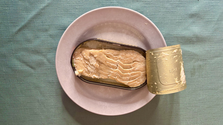 An open can of Polar canned salmon on a white plate