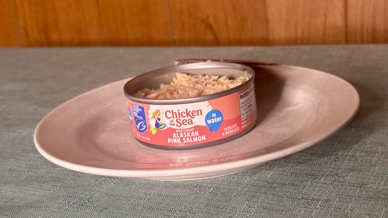 An open can of Chicken of the Sea canned salmon on a white plate