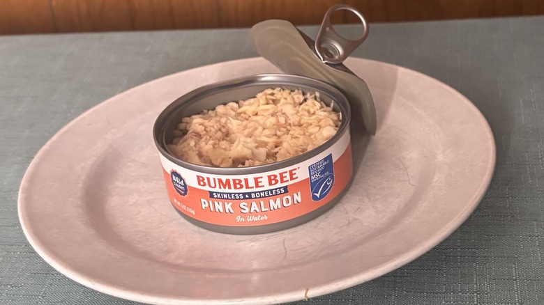 An open can of Bumble Bee canned salmon on a white plate