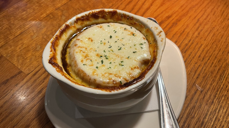The French onion soup from Outback on a white plate