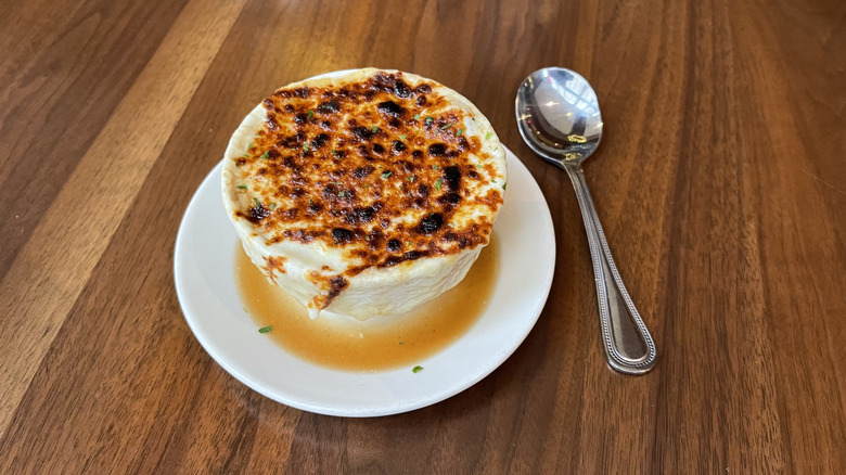 The French onion soup from The Capital Grille on a white plate