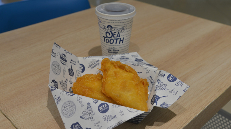 Fried fish meal from Long John Silver's on a wooden table.