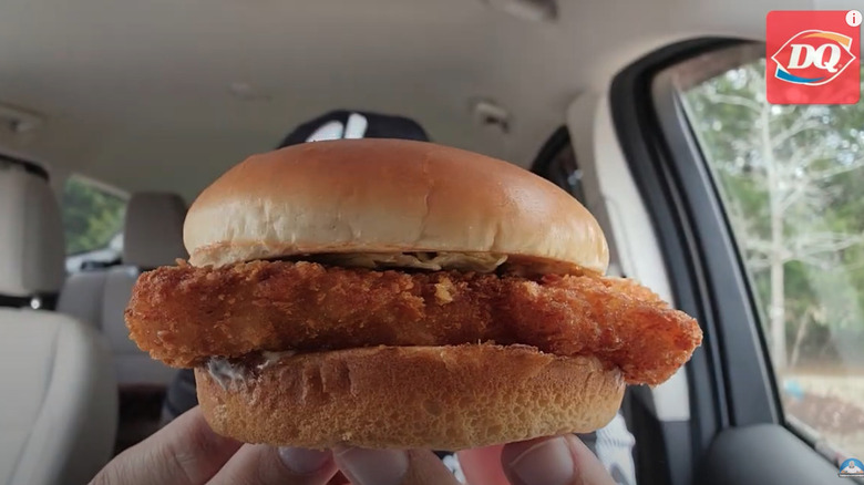Screen grab of a YouTube video of someone trying the Dairy Queen fish sandwich in their car